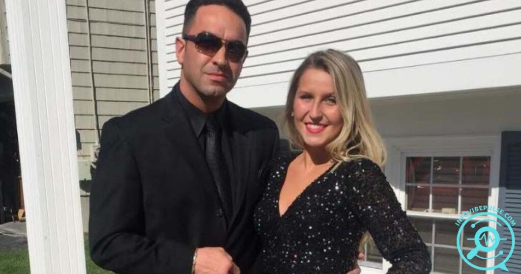 Dino Guilmette in a black suit with sunglasses, posing beside a smiling woman in a black sequin dress outdoors.