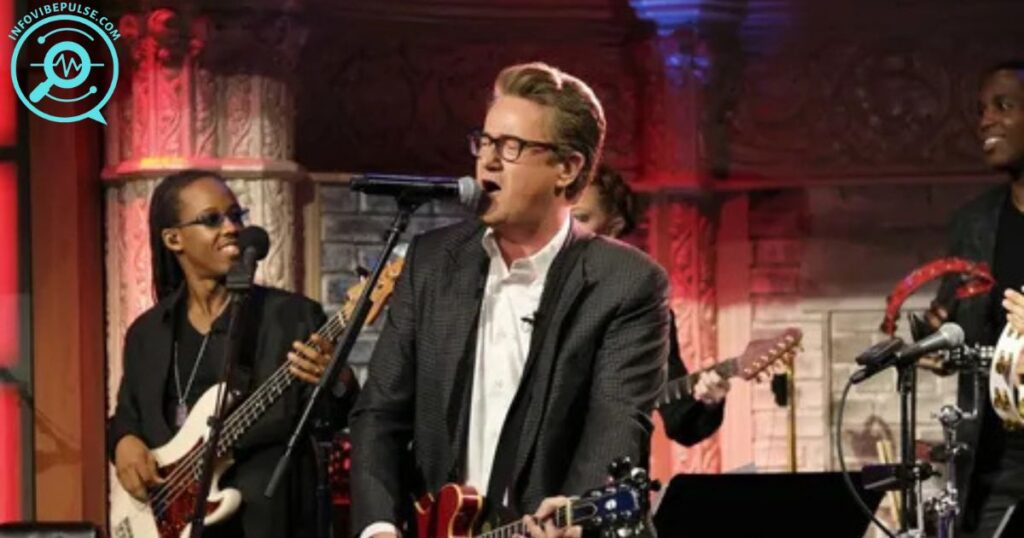 Live music performance featuring band members on stage with guitars and bass in an intimate concert venue setting