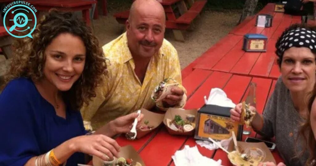 Rishia Haas enjoying a meal outdoors with friends, including Andrew Zimmern, during a casual gathering.