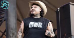 That Mexican OT on stage in a cowboy hat and sleeveless shirt.