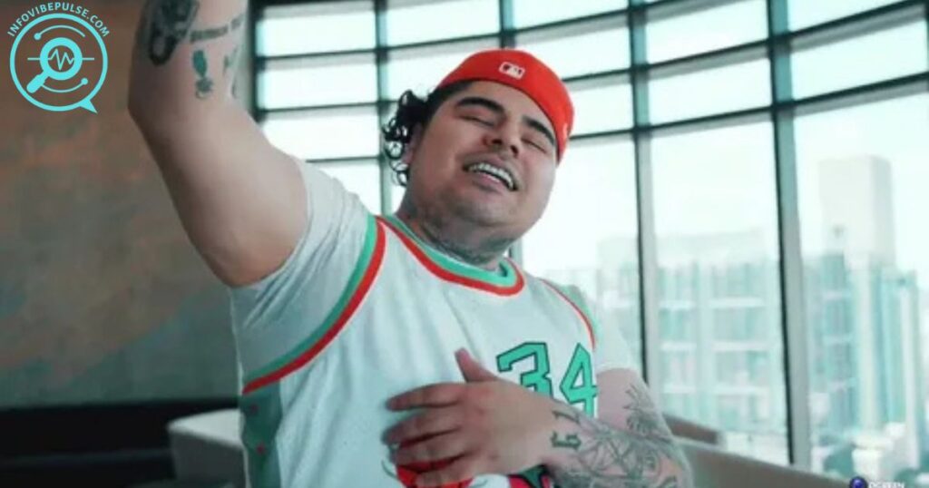 That Mexican OT in a red cap and jersey posing indoors