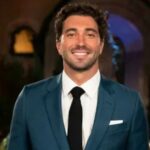 Thor Herbst smiling in a suit, known for his off-road racing career and relationship with Daisy Kent from The Bachelor.